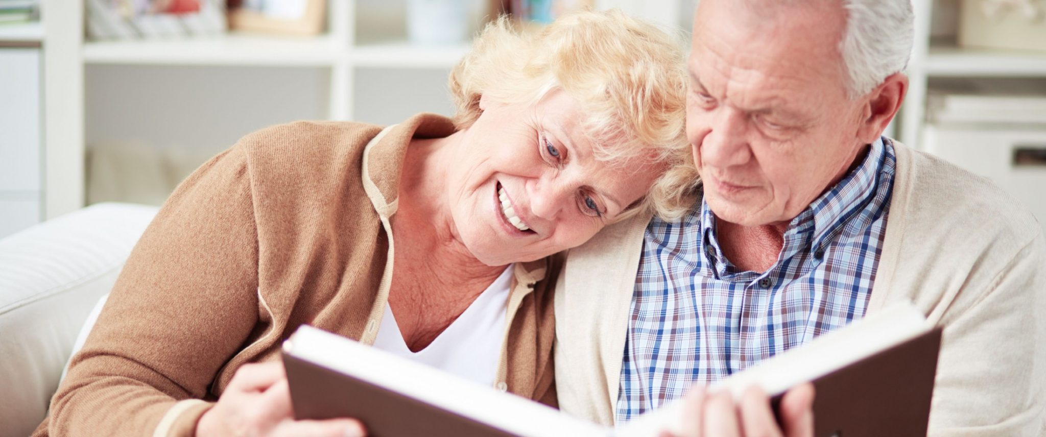 senior couple looking at a photo album together