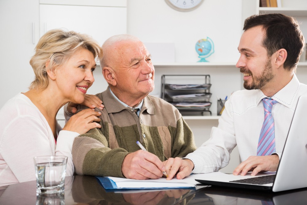 Happy senior couple meeting with their agent