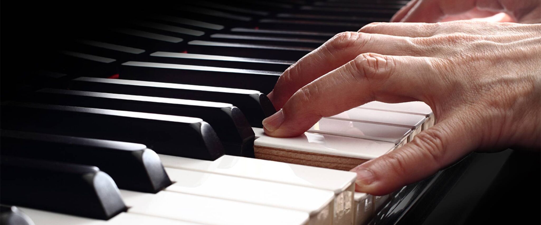 senior playing the piano