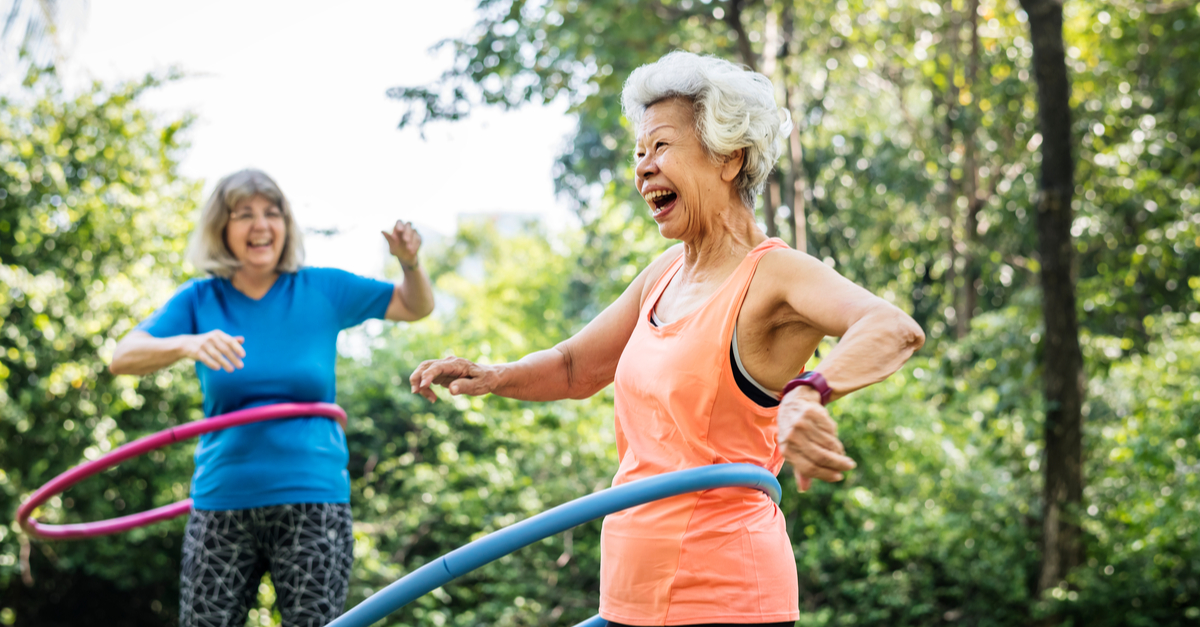 Happy senior women exercising with a hula hoop