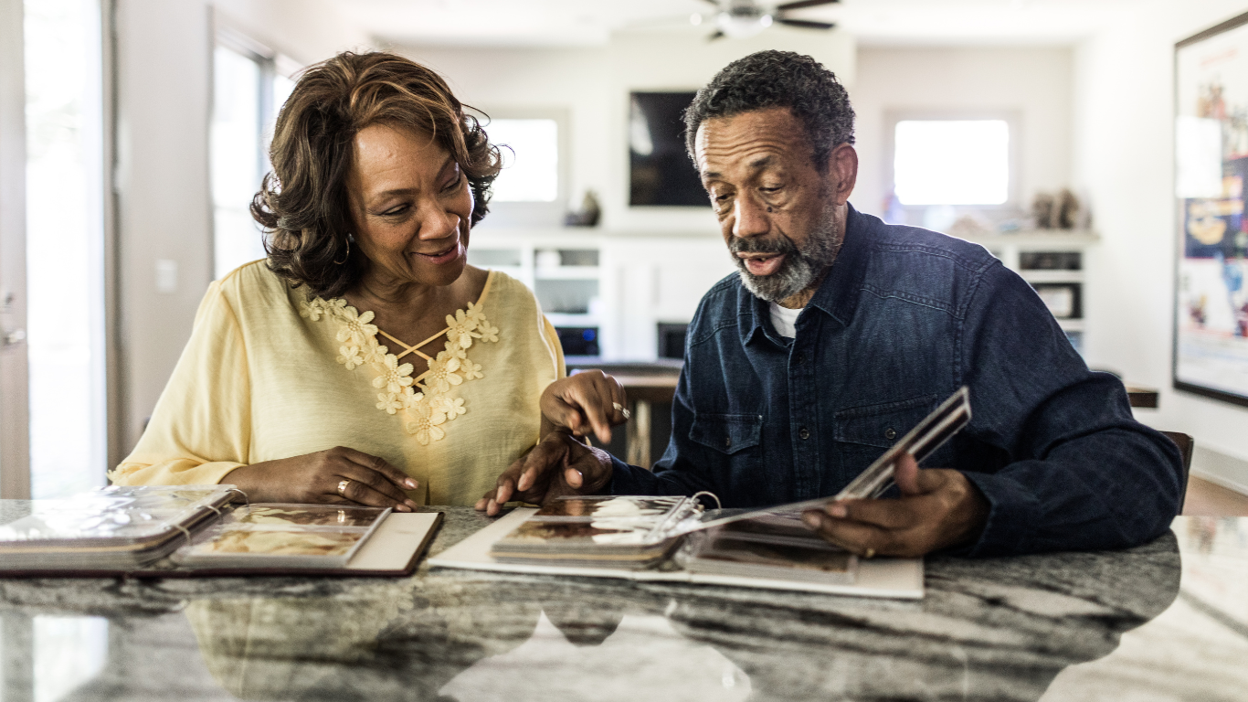 Senior couple looking at photo albums together