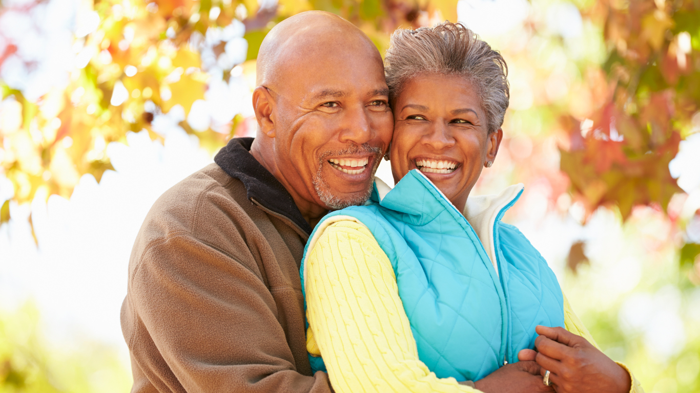 Smiling senior couple embracing outdoors