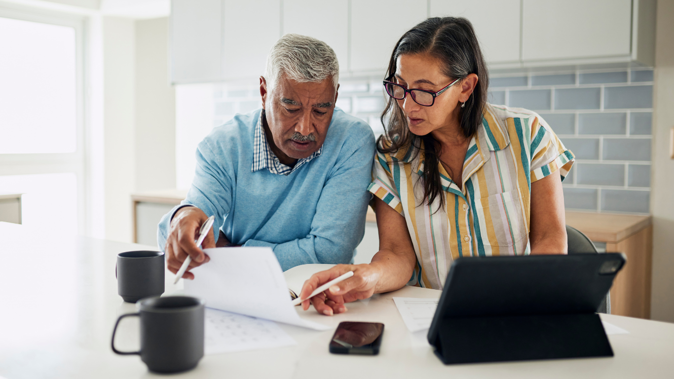Senior man and woman looking at paperwork together