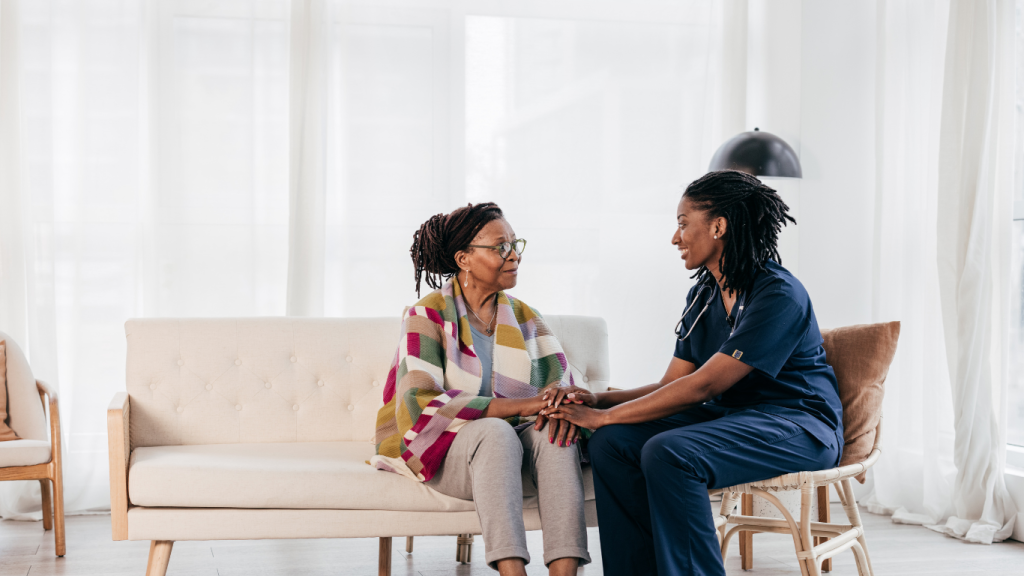 Senior woman with female nurse sitting down