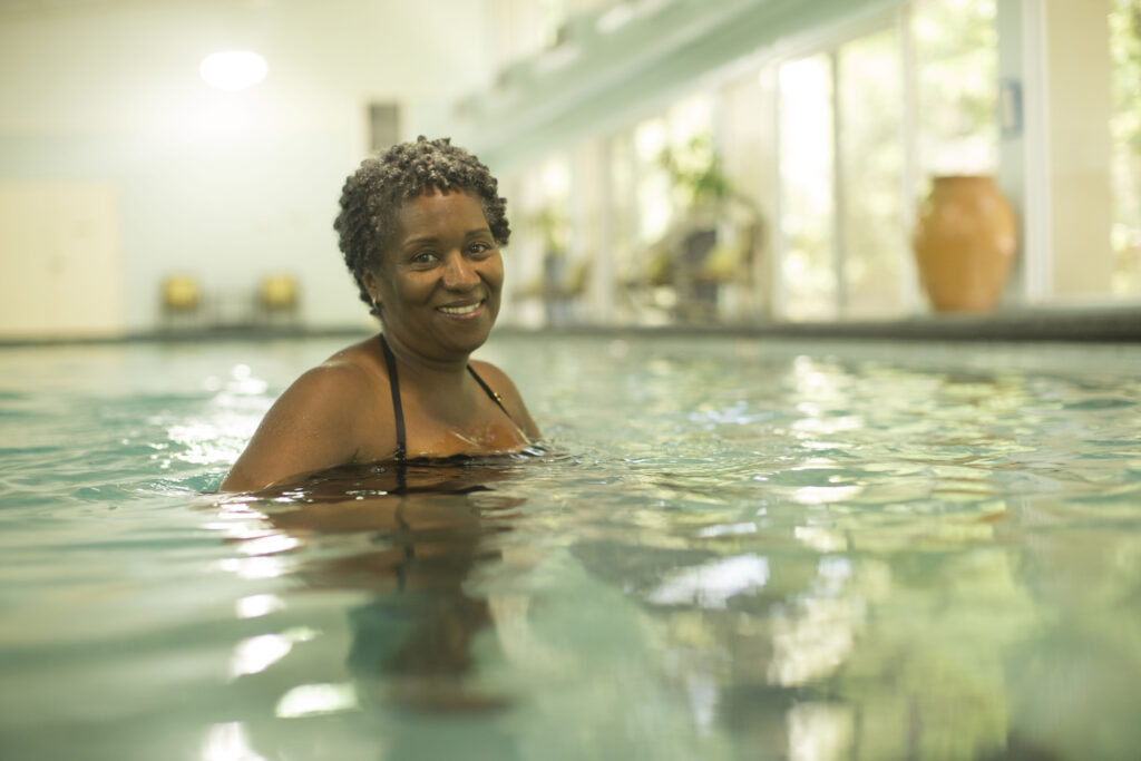 Resident swimming at pool at Cypress Village