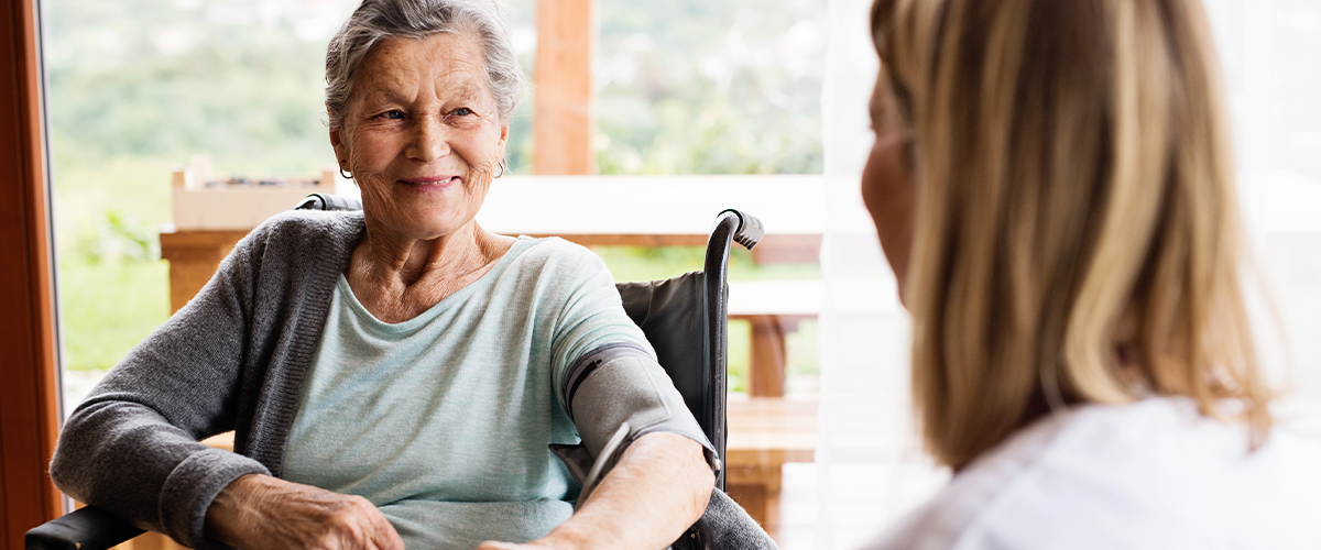 senior woman chats with senior health professional