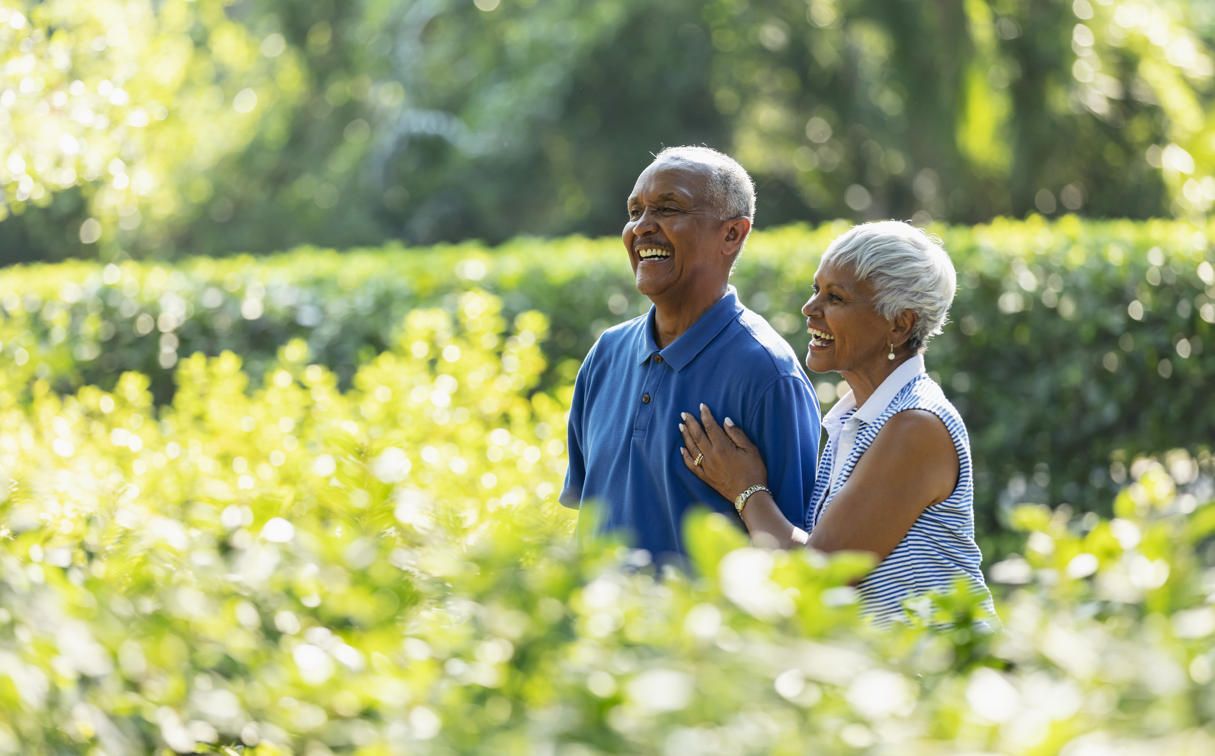Senior couple smiling while on outdoor walk